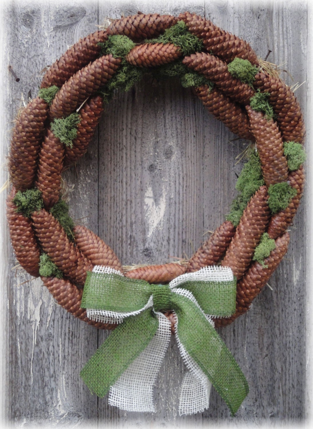 Welcome Christmas wreath made with pine cone, moss and burlap ribbon