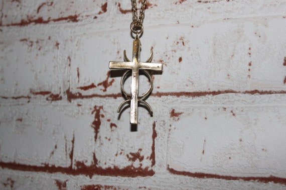Reversible brass cross necklace