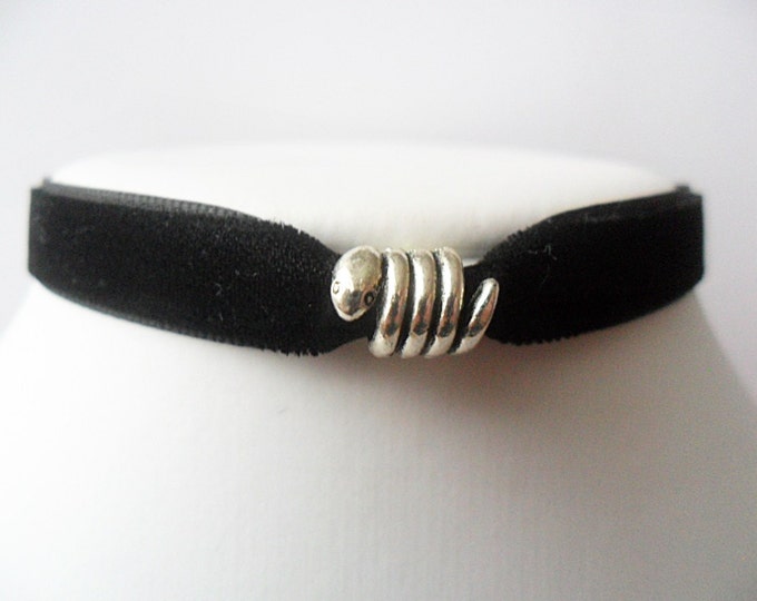 Black velvet choker necklace with snake bead and a width of 3/8”inch.