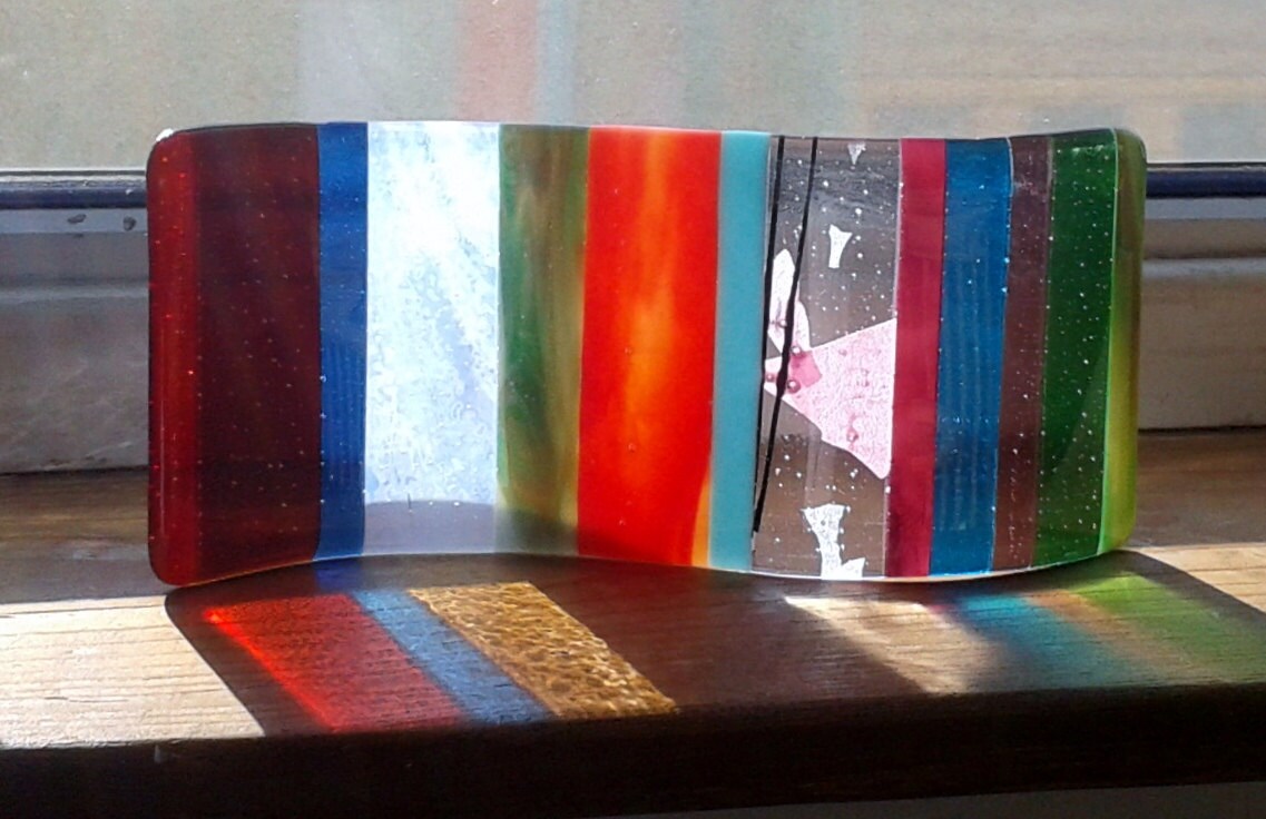 Multi-coloured double curve fused glass ornament