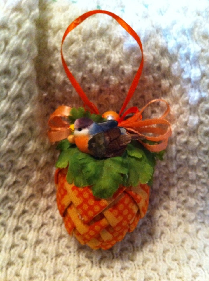 Orange patterned fabric pinecone decoration.