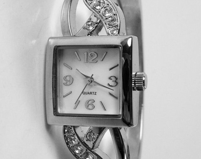 Storewide 25% Off SALE Ladies Silver Tone Diamond Rhinestone Set Designer Quartz Watch Featuring White Bezel And Cuff Bracelet Design