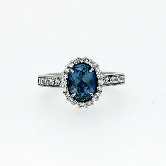 Oval cut London blue topaz halo engagement ring with diamonds