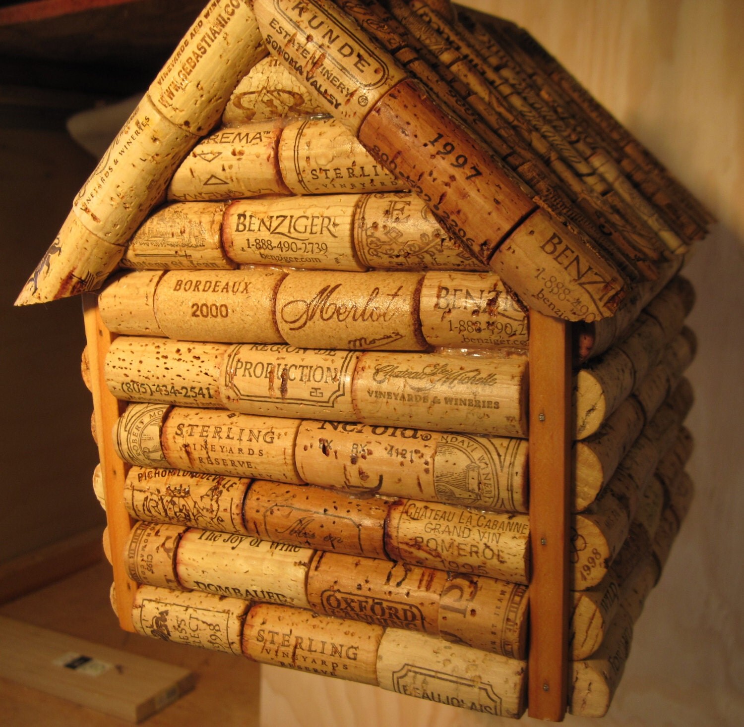 Wine cork and wooden log cabin style birdhouse