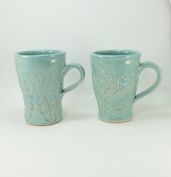 pair of light green mugs with leaves sold together