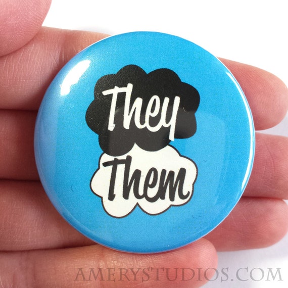 Pin-back button with a blue background and text that reads "they/them"