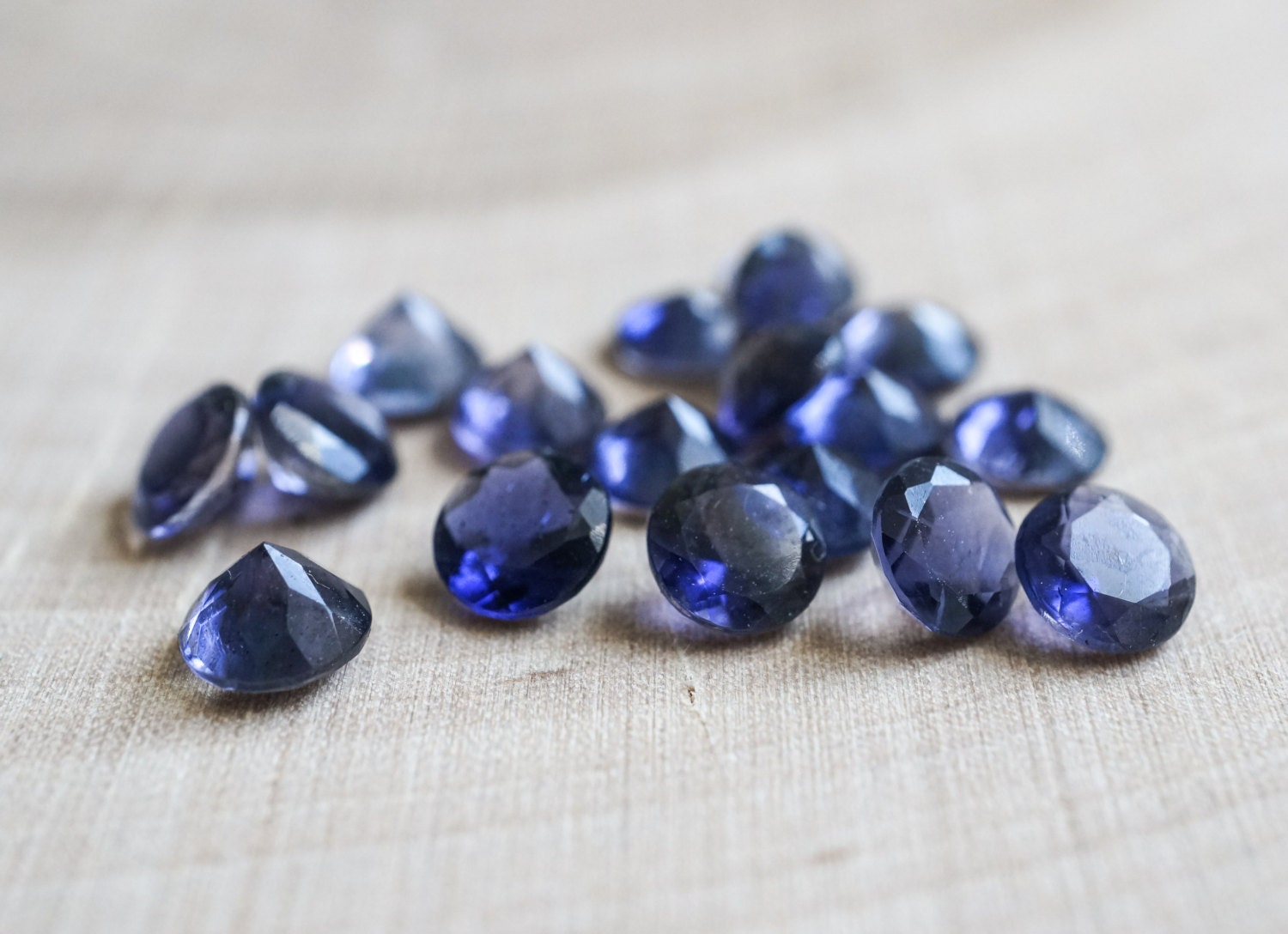 5mm faceted iolite gemstones. violet gems. brilliant cut.