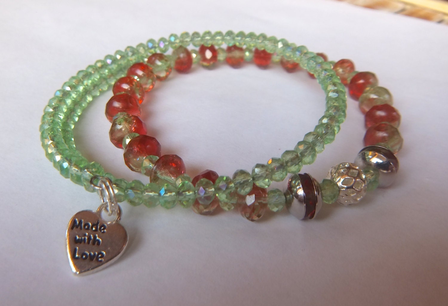 Two Bracelets Featuring a Stretch of Red and Green by NonisFancies