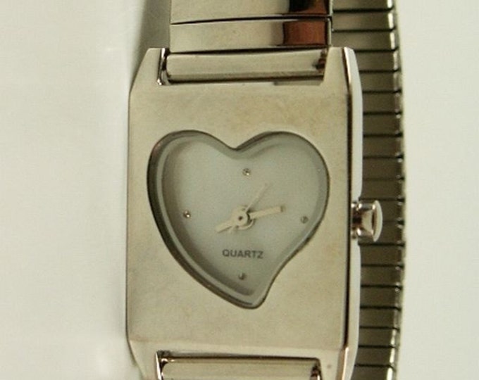 Storewide 25% Off SALE Vintage Ladies Heart Shaped Open Watch Face Designer Timepiece Featuring a Flexible Silver Tone Stretch Band