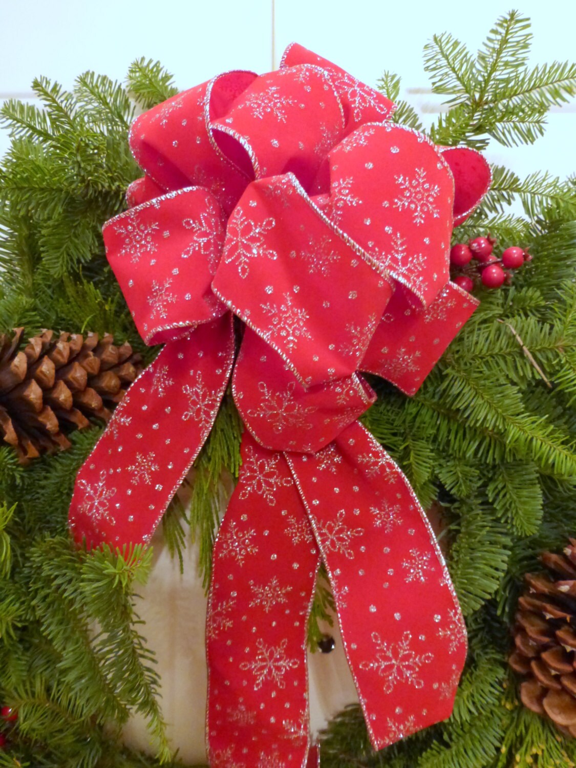 Red Christmas bow with silver snowflakes, wreath bow