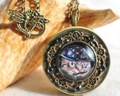 Music box locket,  round locket with music box inside, in bronze with Steampunk Cat cabochon on front cover.
