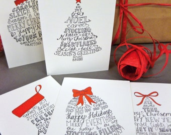 10 Hand-lettered Christmas card pack with five festive designs and red envelopes. 10 cards and envelopes in each pack.