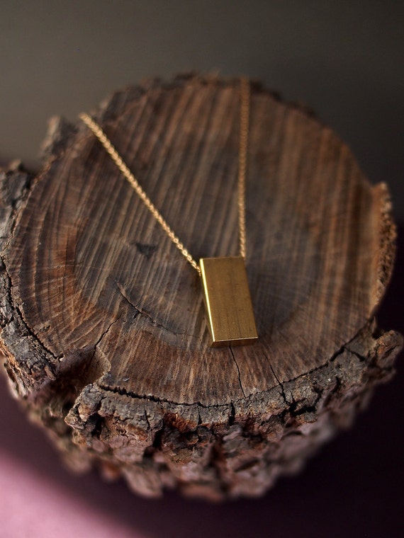 counterweight. raw brass rectangle charm necklace. 14 kt gold