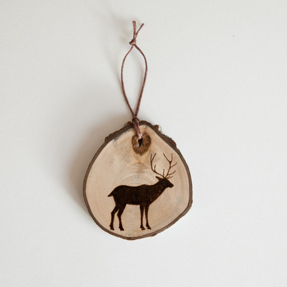 Rustic Wood Slice Ornament with Burned Deer Silhouette.