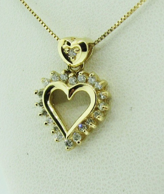 14 K gold and diamond double heart pendant with chain.