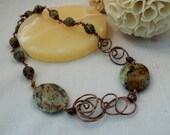 Copper and moss agate necklace.Twisted copper swirl design. Green agate. Spiral design. Asymmetrical design.Copper jewelry.Twisted copper. Copper and moss agate necklace.Twisted copper swirl design. Green agate. Spiral design. Asymmetrical design.Copper jewelry.Twisted copper.