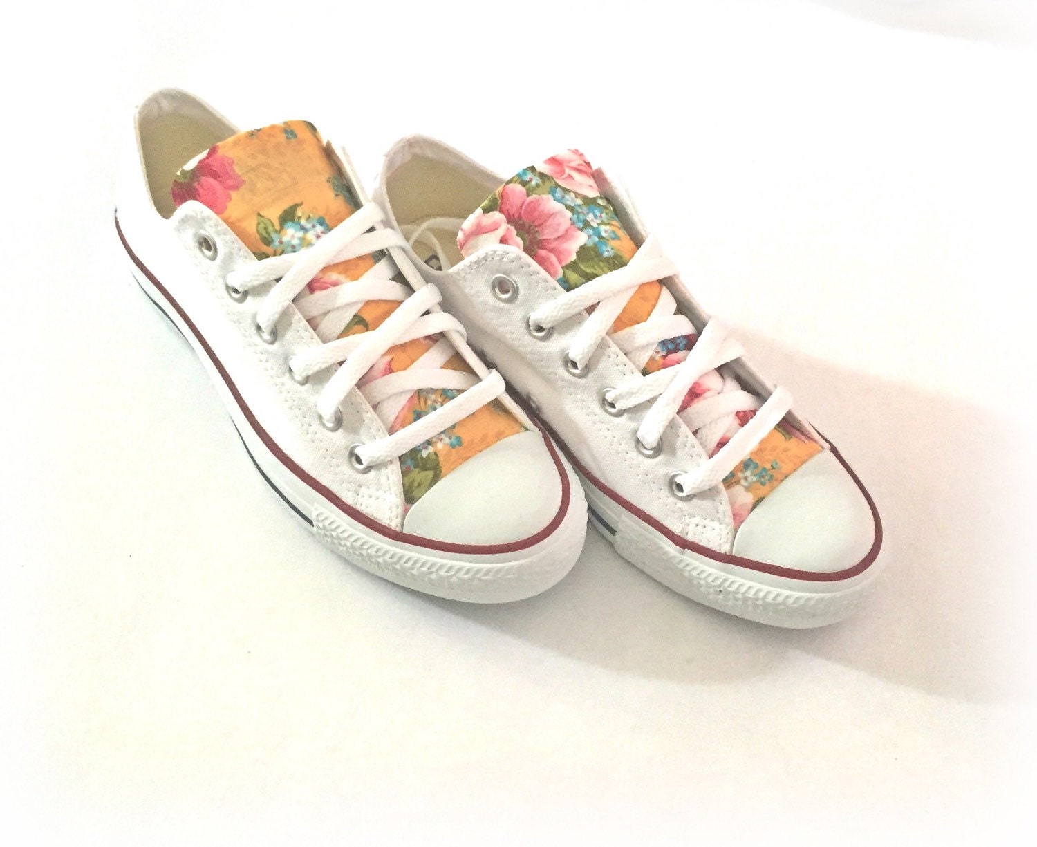 white sneakers with flowers on them