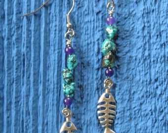 Earrings made whit glass beads and a metal fish bone