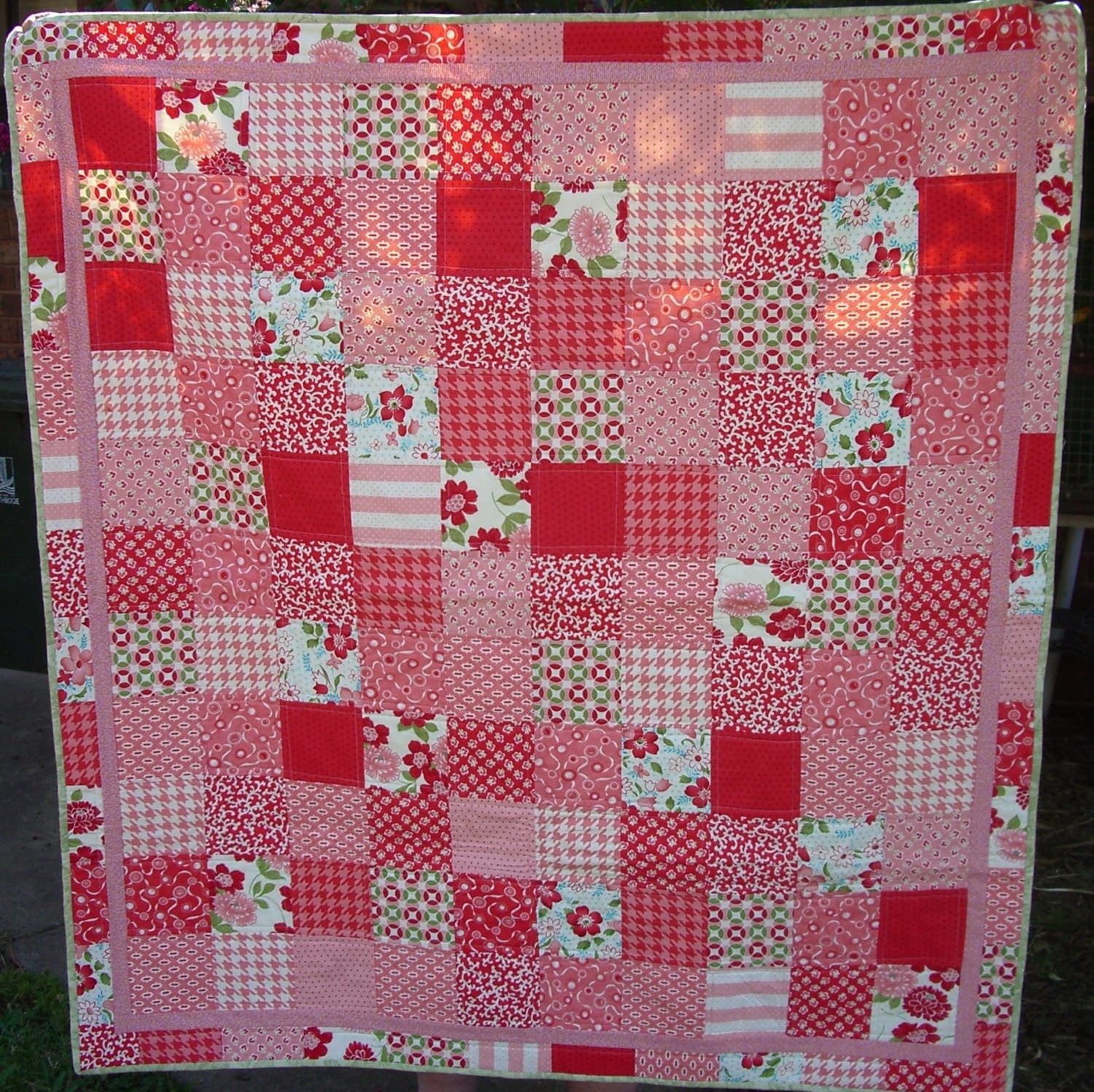 Handmade modern quilt using pink red and green fabric from