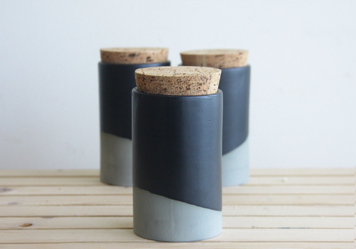 Ceramic jar with cork lid in gray with black matte glaze.