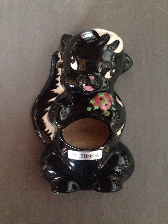 ceramic skunk figurines