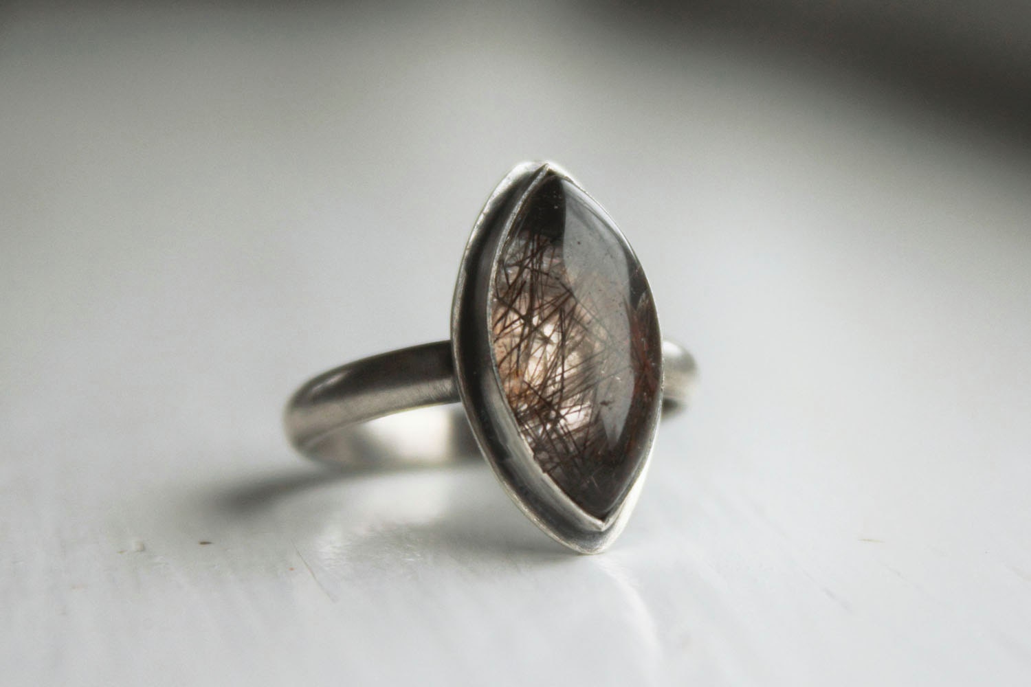 black rutilated quartz gemstone ring. smooth by