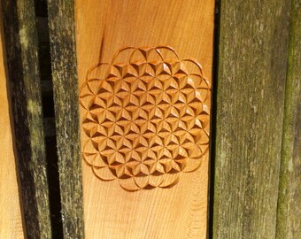 wood carving using sacred geometry flower of life created using traditional swiss technique