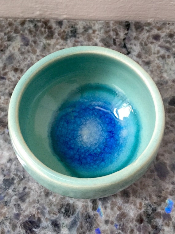 Aqua ceramic ring bowl with dark blue sea glass melted inside