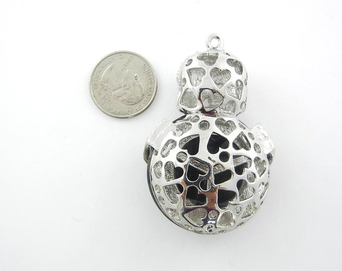 Silver-tone Dimensional Skull Holding Acrylic Black Marble Disk Pendant