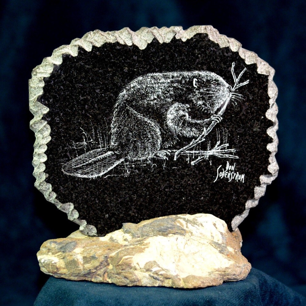 Beaver etched on black granite tile