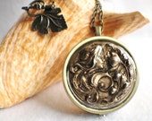 Music box locket, round locket with music box inside, in silver with Victorian Maiden in garden