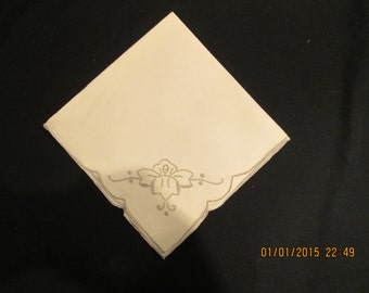 11 Cream colored napkins embroidered with darker beige