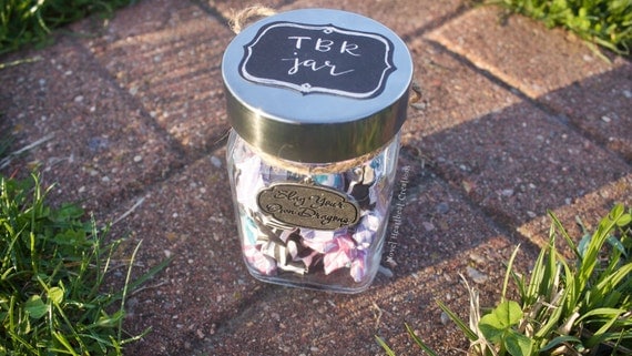 Small bookish "TBR Jar" with origami star book titles, "Slay your own dragons" charm