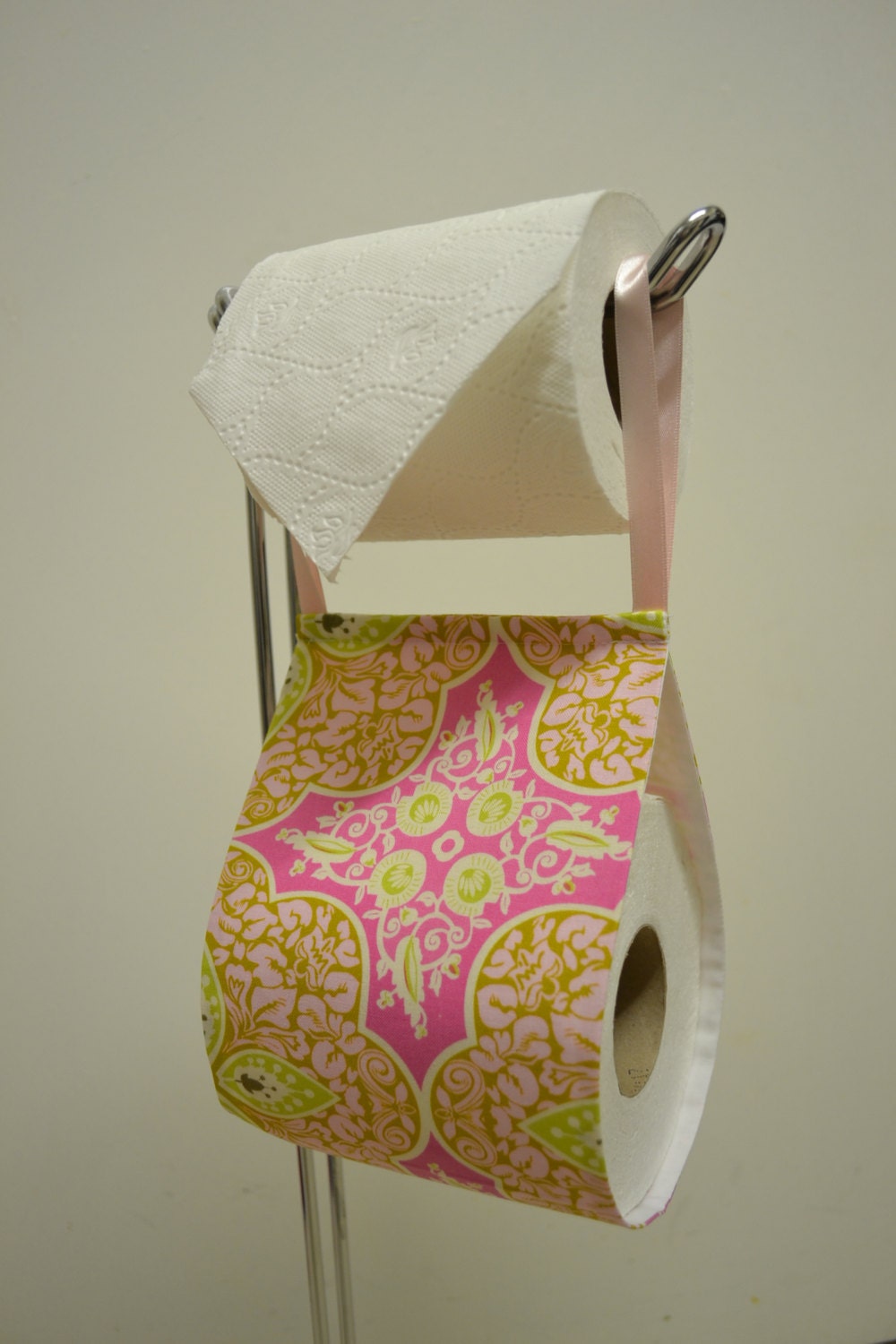 The decorative toilet paper holder storage with fabric pink.