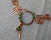 Statement piece. spiral copper necklace.  Wire wrapped by hand.  Statement necklace. Green flower beads. sprial design.  Choker style.