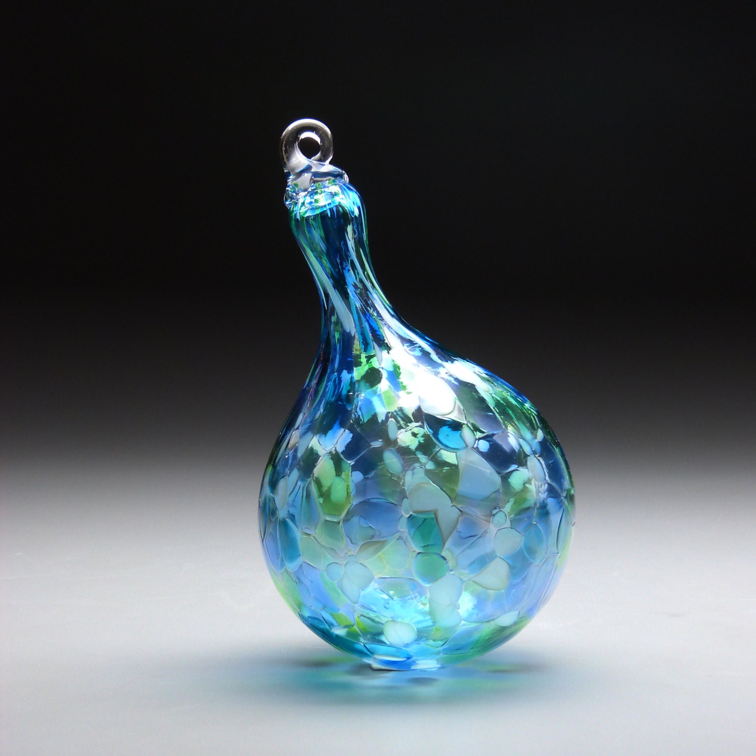 hand made blown glass teardrop ornament in tones of green