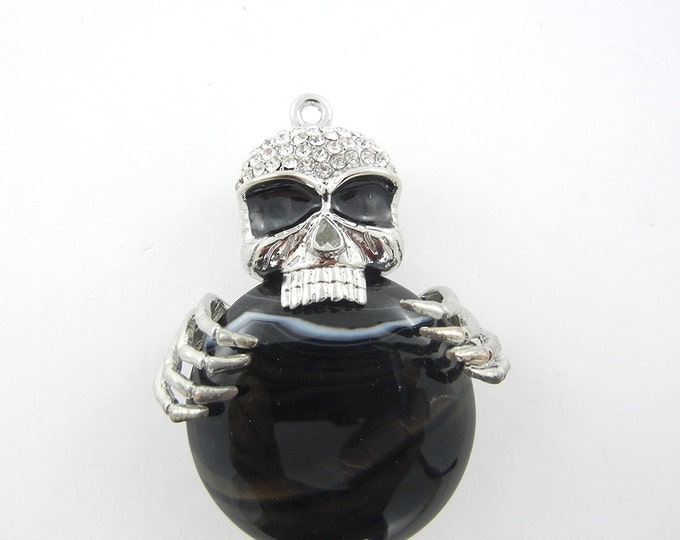 Silver-tone Dimensional Skull Holding Acrylic Black Marble Disk Pendant