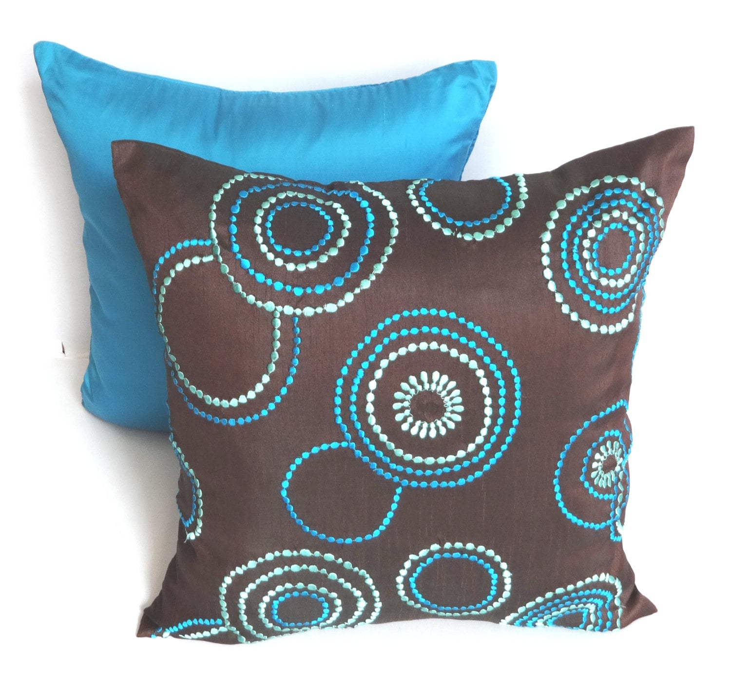Brown throw pillow embroidered w/ teal blue and aqua blue