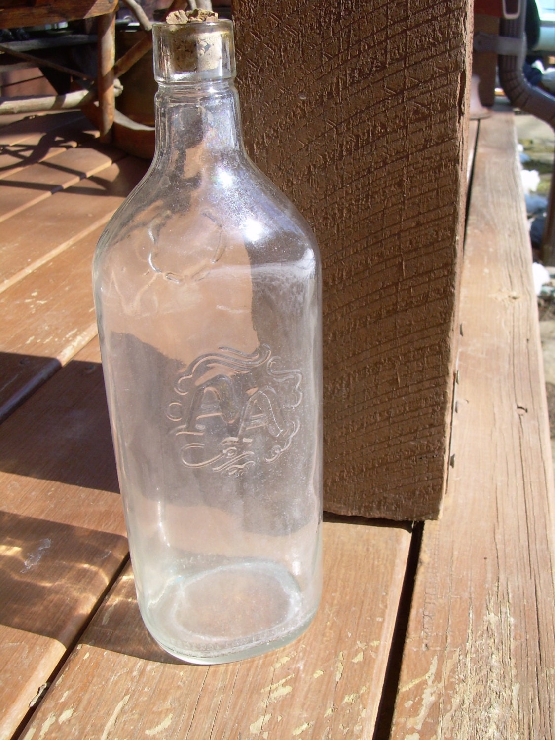 Vintage Embossed AA Clear Glass Liquor Bottle by PiecesOfPastimes