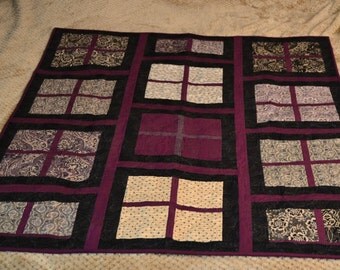 Quilted wall hanging or lap quilt. Machine pieced and quilted in beautiful purple, black & off white downtown abbey fabrics