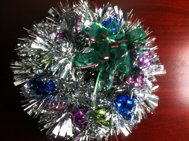 SALE - NOT IDENTICAL -Ropes of tinsel, wrapped around a wire circle, make a fun, modern wreath that you can use year after year.