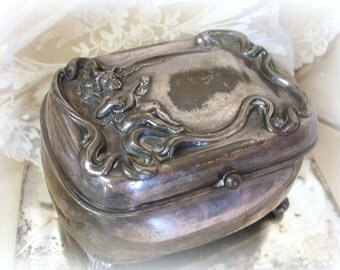 antique art nouveau jewelry casket with cherub . cherub with musical instrument repousse silver plated trinket box with hinged lid