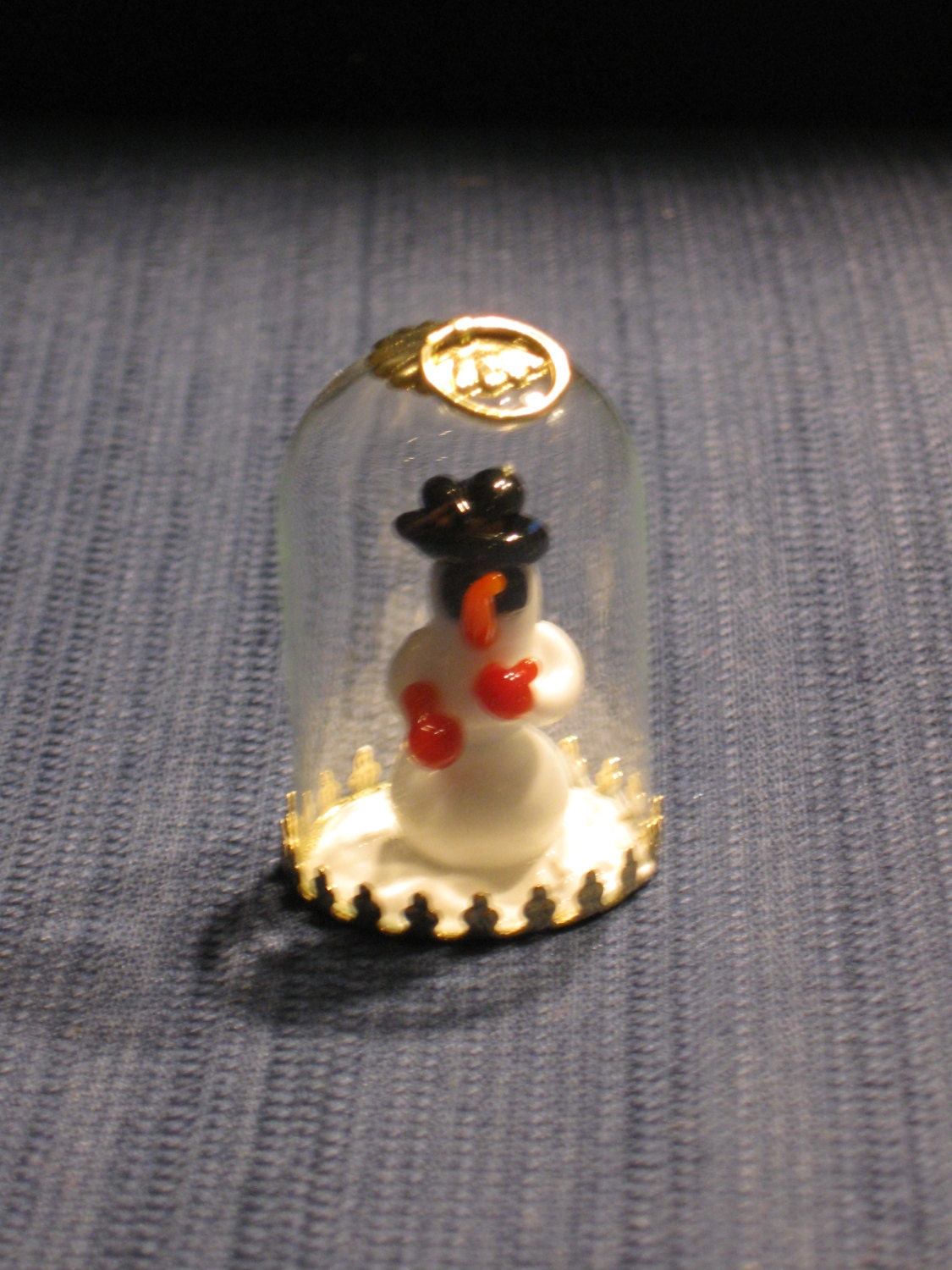 One of a kind tree ornament with hand crafted lampwork glass 'film noir' snowman wearing fedora in blown glass globe