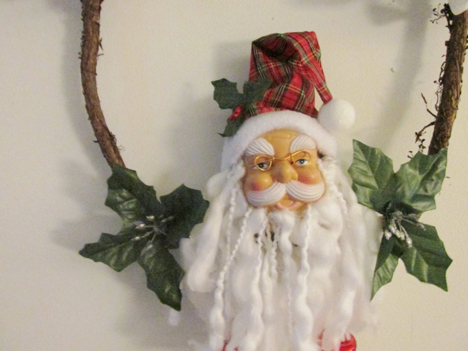 A Locust vine is home to Santa, Holly King, Father Christmas, yule, christmas, winter, solstice wreath with silk poinsettias and silver