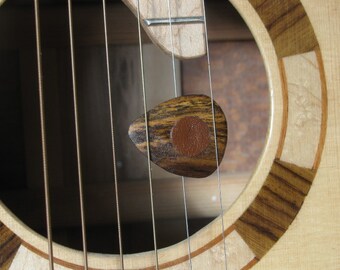 Exotic Bocote wood guitar pick with leather friction pads.