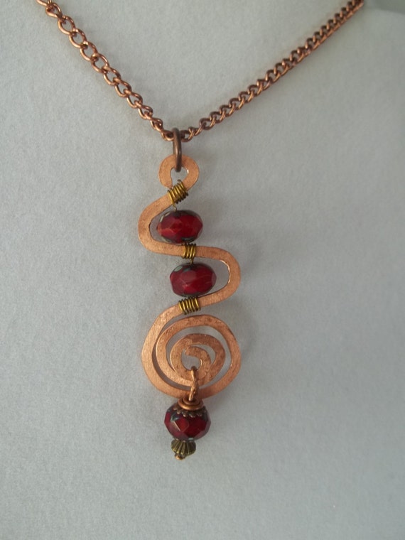 Items similar to Hammered copper necklace with red czech beads ...