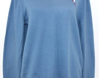 Slate blue cashmere cotton sweater embroidered with abstract flower design.
