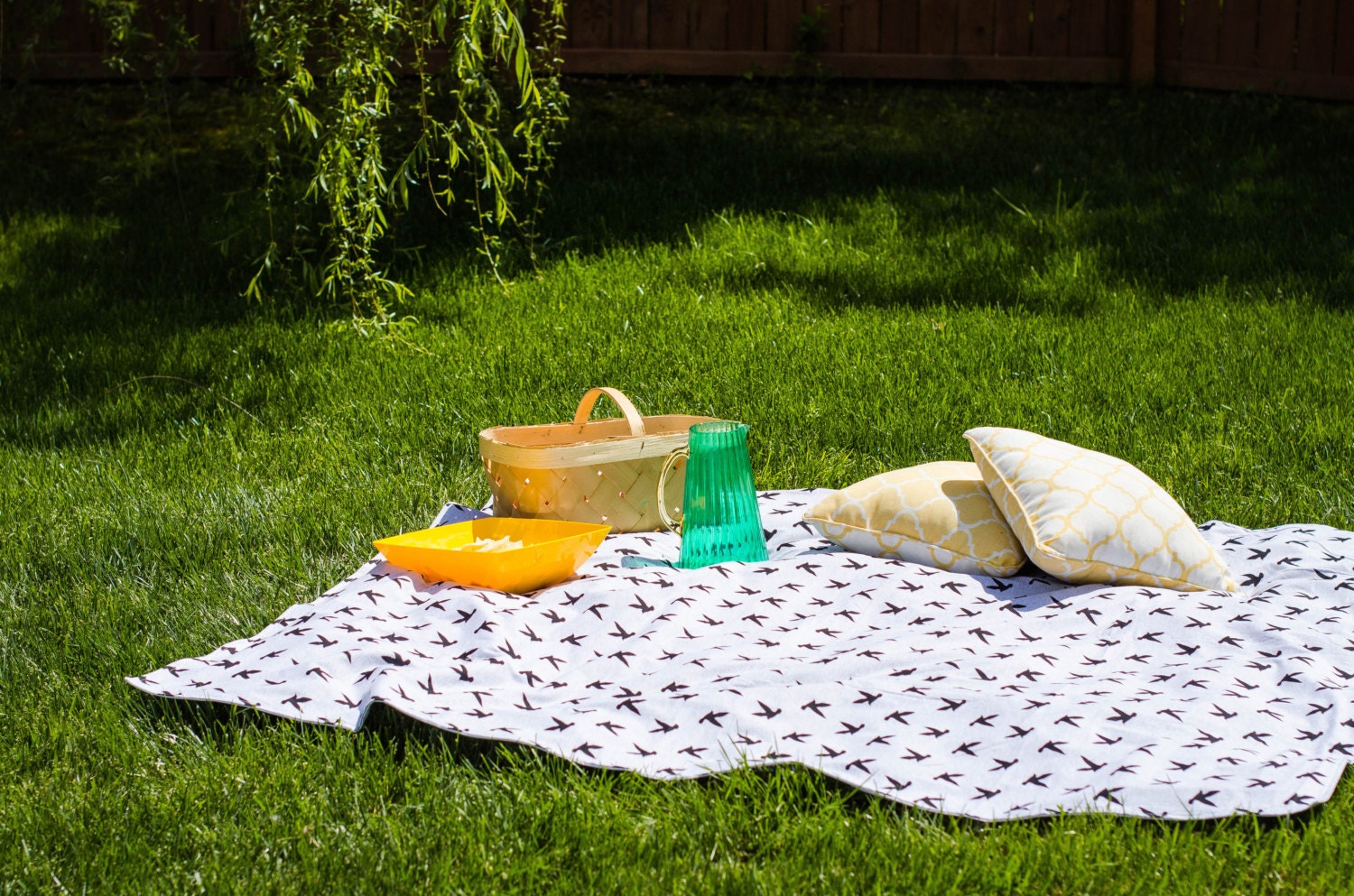 Family sitting on picnic blanket in park giving mature ...