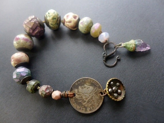 Eudaimonia. Rustic assemblage bracelet with lilac and green art beads, coin, cut steel shaft button.