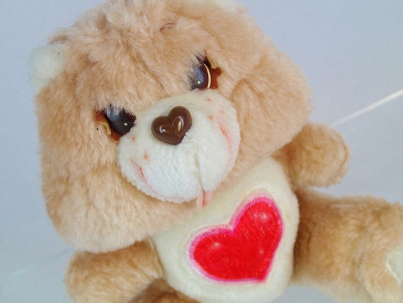 brown care bear with heart